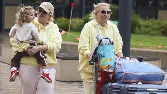 Rebel Wilson and Ramona Agruma arrive in Australia with their daughter Royce, in their first visit back to Australia since their September wedding. Picture: Media Mode