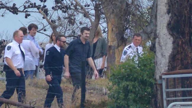 Gene Bristow (in the blue short-sleeved shirt) with sheriff’s officers when the jury and court staff toured his property in Meningie. Picture: Brenton Edwards