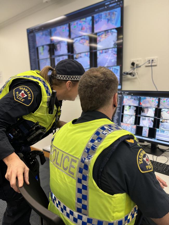 Officers at Hobart Police Station examine live CCTV footage from cameras in Hobart's CBD. Picture: Tasmania Police