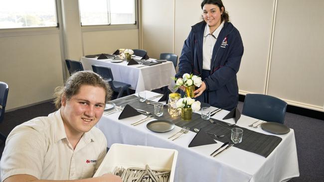 Toowoomba State High School students Blake Wemmerslager and Tamorah Beezley prepare the tables for their restaurant night. Picture: Kevin Farmer