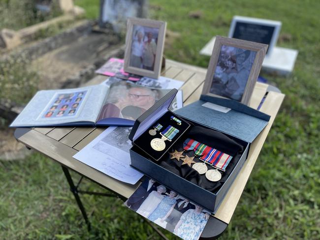 Family photos and wartime medals at the tombstone ceremony for John Patton supported by Mackay RSL. Photo: Zoe Devenport