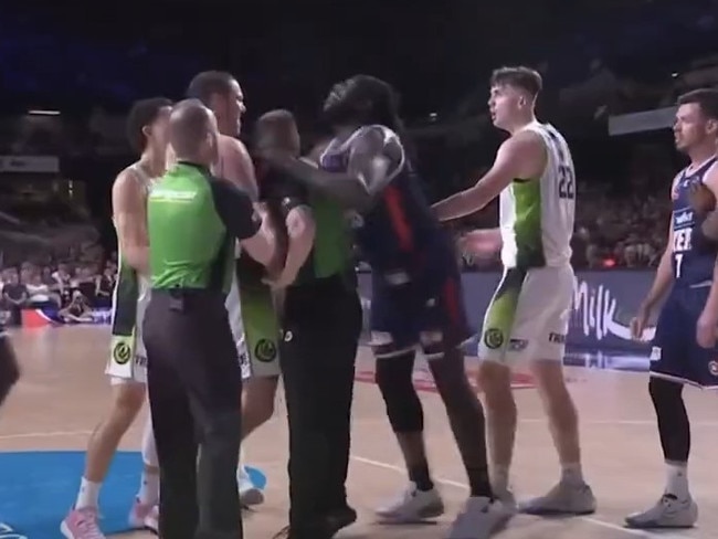 Adelaide's Montrezl Harrell makes contact with referee Hugh Starkey during an altercation with Phoenix strongman Tom Vodanovich.