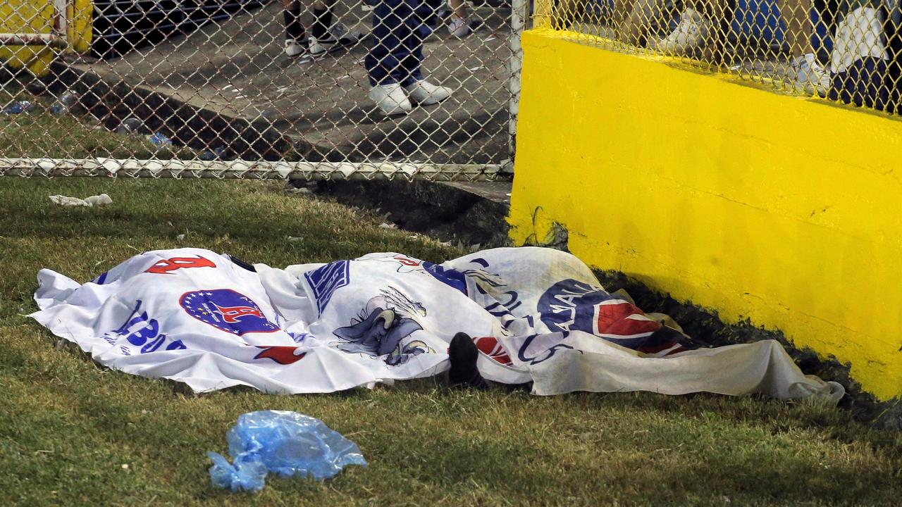 Victims’ bodies are seen covered with Alianza’s flags following the stampede which saw at least 12 people killed. Picture: Milton Flores/AFP