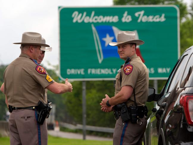 Texas state troopers patrol the border with Louisiana in Orange, Texas on Thursday. Picture: MARK FELIX/AFP