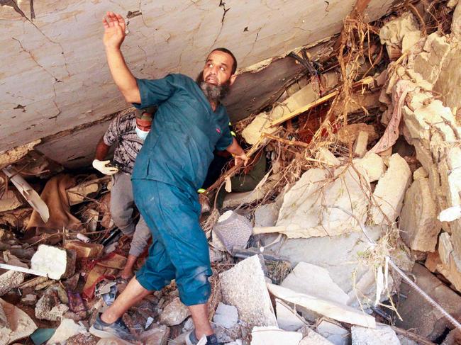 People search in the rubble of a building in a flash flood-damaged area in Derna, Libya. A global aid effort gathered pace this week after a tsunami-sized flash flood killed at least 11,000 people, with thousands more missing. The UN has blamed the death toll in part on the legacy of years of war and chaos. Picture: Abdullah Doma/AFP