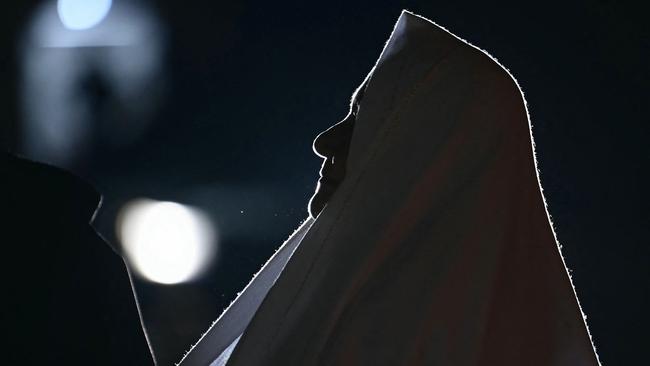 A nun prays at the statue of John Paul II outside the Gemelli University Hospital where Pope Francis is hospitalised with pneumonia, in Rome on March 03, 2025. (Photo by Filippo MONTEFORTE / AFP)