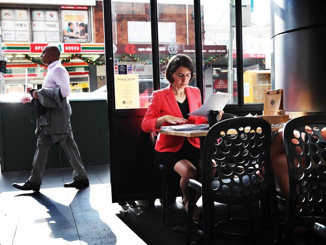 NSW Premier Gladys Berejiklian still works, even when stopping for an early morning coffee in a Strathfield cafe earlier this week. Picture: Phil Hillyard