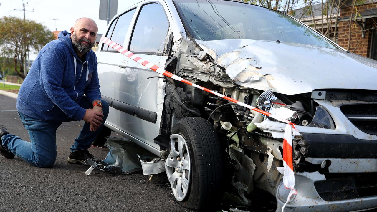 Dean Peterson with his wife's smashed car in Chaucer St, Hamlyn Heights. Picture: Alison Wynd