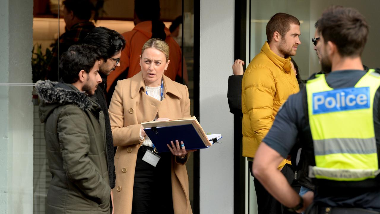 Police speak to store employees. There is no suggestion they were involved in the fire. Picture: NCA NewsWire / Andrew Henshaw