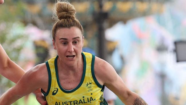 Australia's #33 Lauren Mansfield dribbles past Canada's #02 Katherine Plouffe (L) in the women's pool round 3x3 basketball game between Australia and Canada during the Paris 2024 Olympic Games at La Concorde in Paris on July 30, 2024. (Photo by David GRAY / AFP)