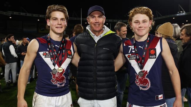 MELBOURNE, AUSTRALIA - SEPTEMBER 16: Will Ashcroft of the Dragons (L) and his younger brother Levi Ashcroft of the Dragons (R) pose for a photograph with their father, former Brisbane Lions triple premiership player Marcus Ashcroft, after the NAB League Grand Final match between the Sandringham Dragons and the Dandenong Stingrays at Ikon Park on September 16, 2022 in Melbourne, Australia. (Photo by Daniel Pockett/AFL Photos/via Getty Images)