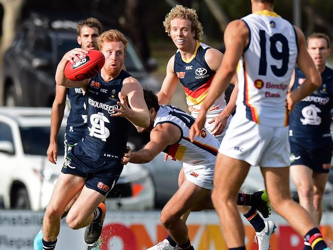 17/06/18 - South Adelaide v Adelaide Crows SANFL match at Hickinbotham Oval, Noarlunga.  South's Nicholas Liddle breaks a tackle from Adelaide's Ben Jarman. Picture: Tom Huntley