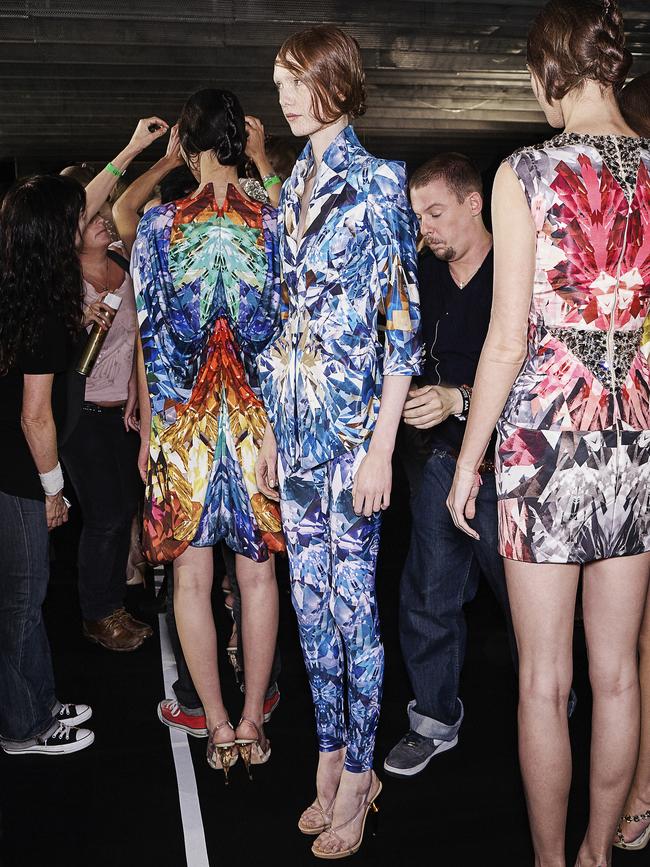 No.1: Alexander McQueen adjusts an ensemble worn by model Kate Somers at his Natural Dis-Tinction, Un-Natural Selection show in Paris. Picture: Robert Fairer