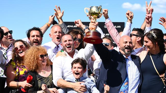 Verry Elleegant owners Brae Sokolski (left holding the Cup) and Ozzie Kheir (right with the Cup) celebrate on Tuesday. Picture: Getty Images