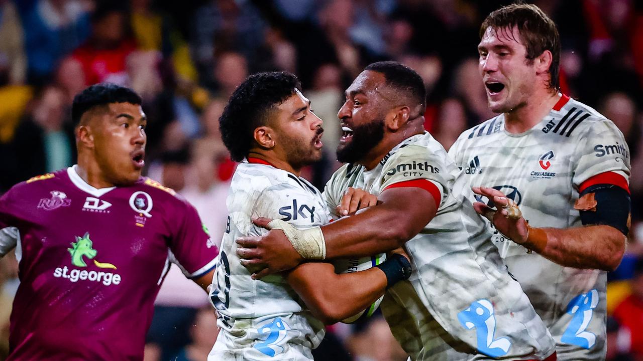 Crusaders' Richie Mo'unga (centre L) scored a hat-trick as the Reds were given a reality check. Photo: AFP