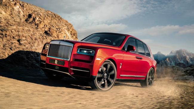 A Rolls Royce driving up a mountain.