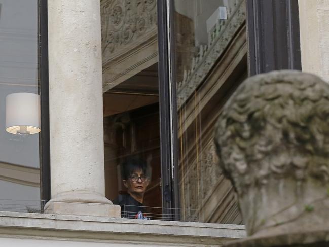 A woman looks out of a window of the Paris residence where Kim Kardashian West was held at gunpoint on October 3, 2016. Picture: AP