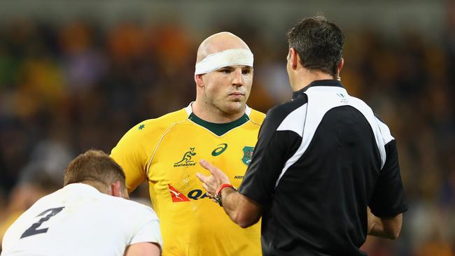 Referee Craig Joubert talks to Wallabies captain Stephen Moore and Dylan Hartley of England.
