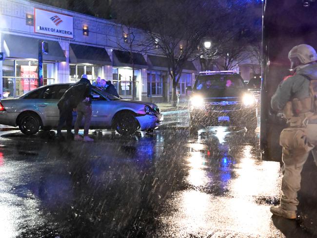 US Secret Service rush to a car after it hit a motorcade SUV in Wilmington, Delaware. Picture: AFP