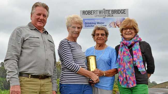 Robert White's great grandson Chris Mitchell, great granddaughter Lyn McLean, granddaughter Phyllis Mitchell and great granddaughter Jill McCann with the newly erected sign and an artillery shell that was presented to Alderman White and his wife Elizabeth at the bridge opening in 1926. It was engraved as a "token of esteem by residents of South Lismore". Picture: Terra Sword