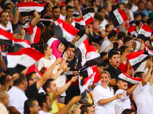 Iraq supporters cheer during the first round Asian Cup football match between Japan and Iraq at the Suncorp Stadium in Brisbane on January 16, 2015. AFP PHOTO / PATRICK HAMILTON ---IMAGE RESTRICTED TO EDITORIAL USE - STRICTLY NO COMMERCIAL USE---