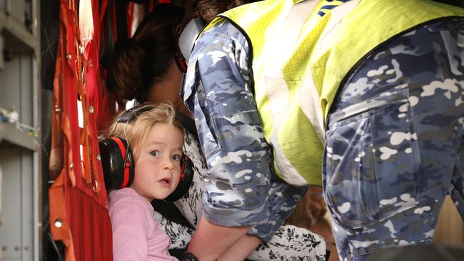 A young girl is strapped in before take-off. Picture: David Caird