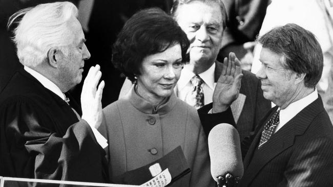 Chief Justice Warren Burger administers the oath of office to Jimmy Carter as the 39th President of the US on January 20, 1977 as Rosalynn Carter looks on. Picture: AFP