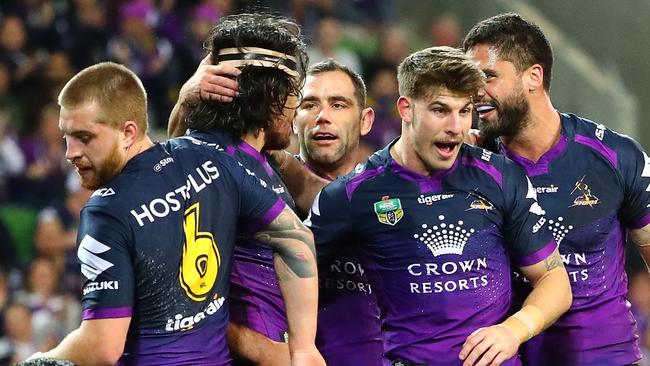 Tohu Harris of the Storm is congratulated by Cameron Smith and his teammates.