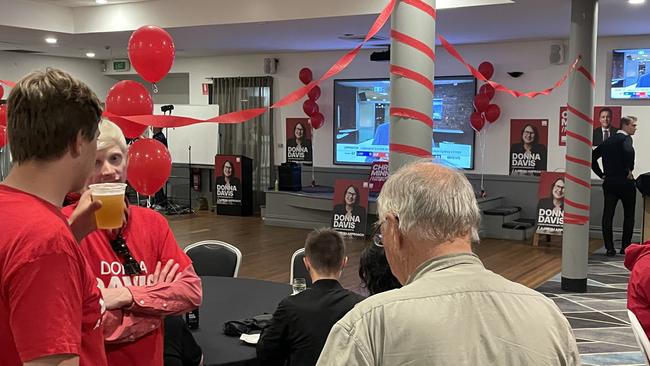 Labor supporters gather at a red-saturated Rosehill Bowling Club before candidate Donna Davis arrives.