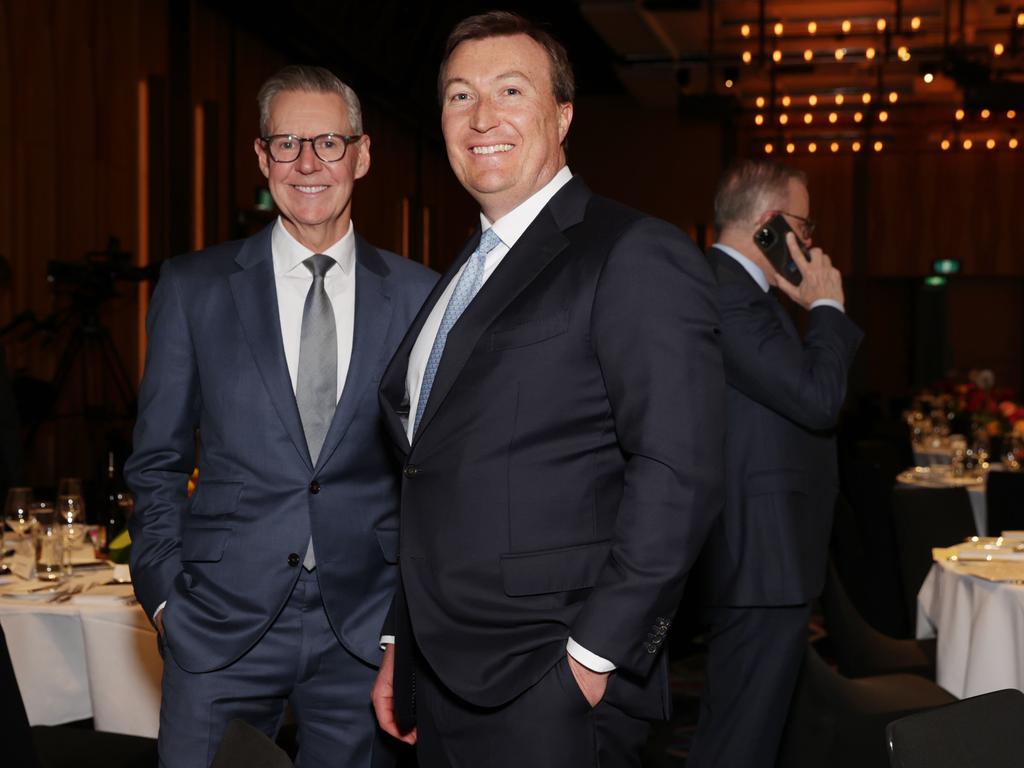 Business Council of Australia president Geoff Culbert and chief executive Bran Black enjoy the festivities as Anthony Albanese takes a call. Picture: Jane Dempster