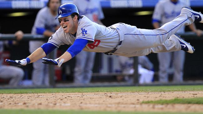 Los Angeles Dodgers' Trent Oeltjen dives into home. (AP Photo/Barry Gutierrez)