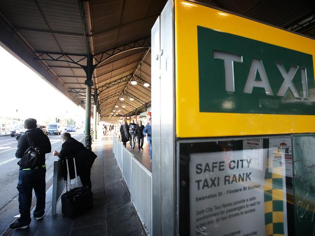 Passengers wait for scarce taxis in the CBD. Pic: Norm Oorloff