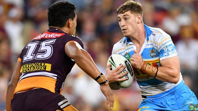 Max King (right) of the Titans takes on Joe Ofahengaue (left) of the Broncos during the Round 4 NRL match. Photo: AAP