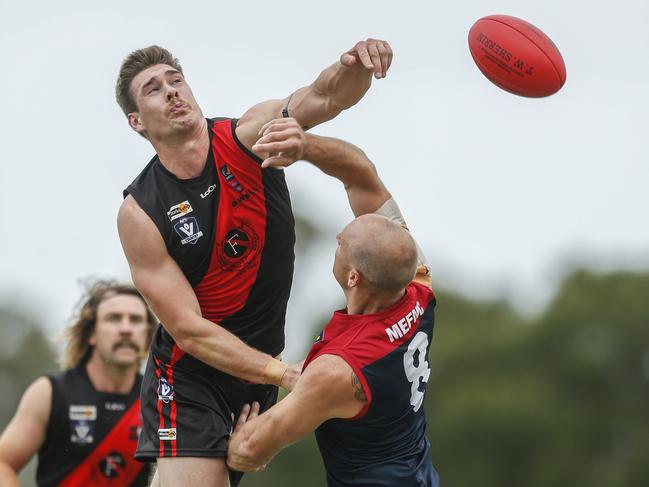 Ruckman Harrison Prior belts the Bombers forward, with Matt Harris in the background.