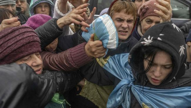 Kherson residents rush for an aid supply distribution after the city was recaptured by Ukraine. Picture: AFP