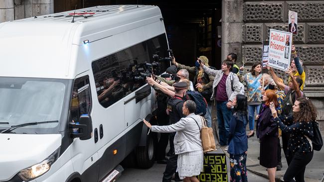 Supporters of Wikileaks founder Julian Assange and members of the media gather at the exit to the Old Bailey as a van believed to be carrying Assange leaves the court.