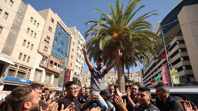 Palestinians in the West Bank city of Nablus celebrate on October 7, 2023, after fighters from the Gaza Strip infiltrated Israel, a major escalation in the Israeli-Palestinian conflict. (Photo by Jaafar ASHTIYEH / AFP)