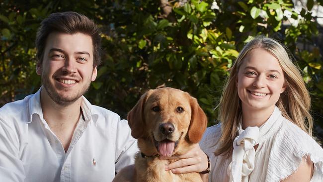 Jack Batty and Charlotte Thomas pose for a picture with their six month old dog Trooper in Eastwood, Sunday, Aug. 13, 2017. (AAP Image/MATT LOXTON)