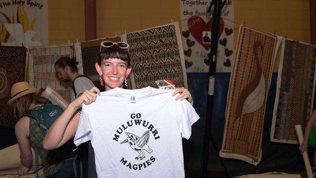 Beck Naylor holds up a T Shirt at the Jilamara Art and Craft Market in Tiwi Island. Picture: Keri Megelus