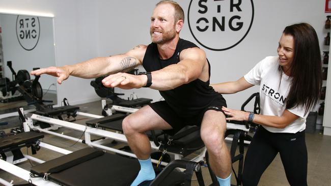 Mel and Dave Willmot demonstrate a workout at their new Strong Pilates studio in Hope Island. Picture: Tertius Pickard