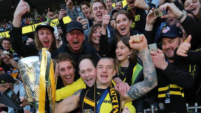 Norm Smith medallist Dustin Martin enjoys Richmond’s success with supporters.