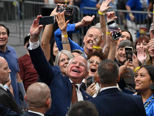 Tim Walz poses for a selfie with supporters after speaking during the rally in Glendale, Arizona. Picture: Robyn Beck / AFP