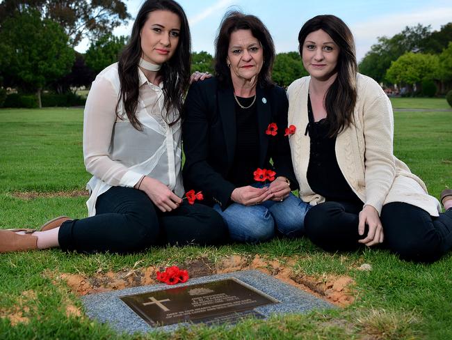 Vicki Crannaford (centre) with her daughters Meegan and Brooke, at the veteran memorial grave of their grandfather and uncle John Tassell at Enfield Memorial Park. Picture: Bianca De Marchi