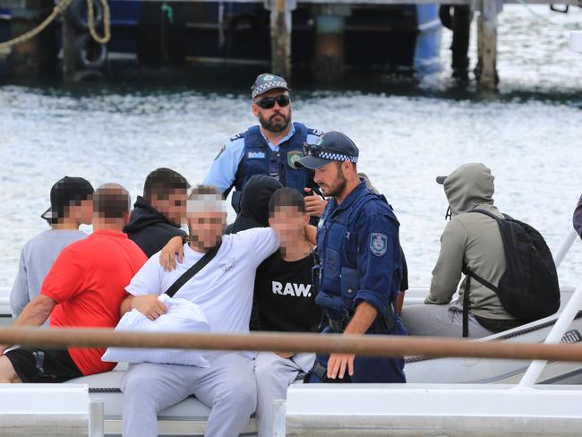 Passengers from the Carnival Legend being taken off the cruise ship by Police in Eden, NSW.