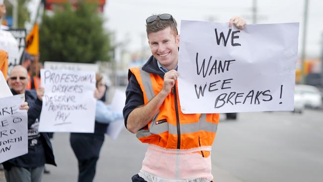 Bus drivers walk off the job for better work conditions and increased pay. Alex Smith wears a diaper and hold a sign saying 'we want wee breaks'. Picture: PATRICK GEE