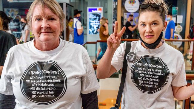 Two protesters with uncovered faces at Chadstone shopping centre. Picture: Jake Nowakowski