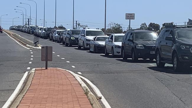 Cars line up across Jervois Bridge for the Port Adelaide COVID-19 testing clinic on Monday, November 16. Picture: Ben Cameron