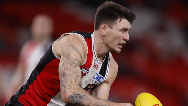 MELBOURNE, AUSTRALIA - AUGUST 04:  Josh Battle of the Saints handballs during the round 21 AFL match between St Kilda Saints and Brisbane Lions at Marvel Stadium, on August 04, 2024, in Melbourne, Australia. (Photo by Darrian Traynor/Getty Images)