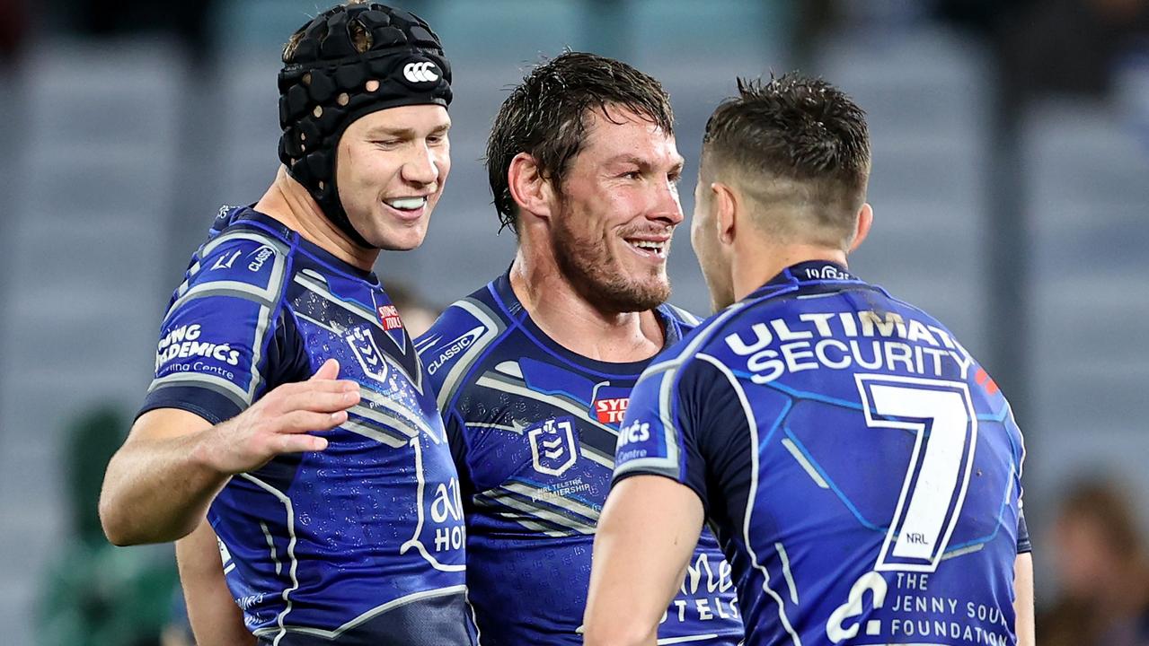 SYDNEY, AUSTRALIA - SEPTEMBER 02: Matt Burton, Josh Jackson and Kyle Flanagan of the Bulldogs celebrates at full time during the round 25 NRL match between the Canterbury Bulldogs and the Manly Sea Eagles at Accor Stadium, on September 02, 2022, in Sydney, Australia. (Photo by Brendon Thorne/Getty Images)