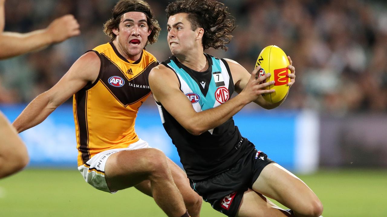 Josh Sinn eludes Jai Newcombe at Adelaide Oval. Picture: AFL Photos via Getty Images
